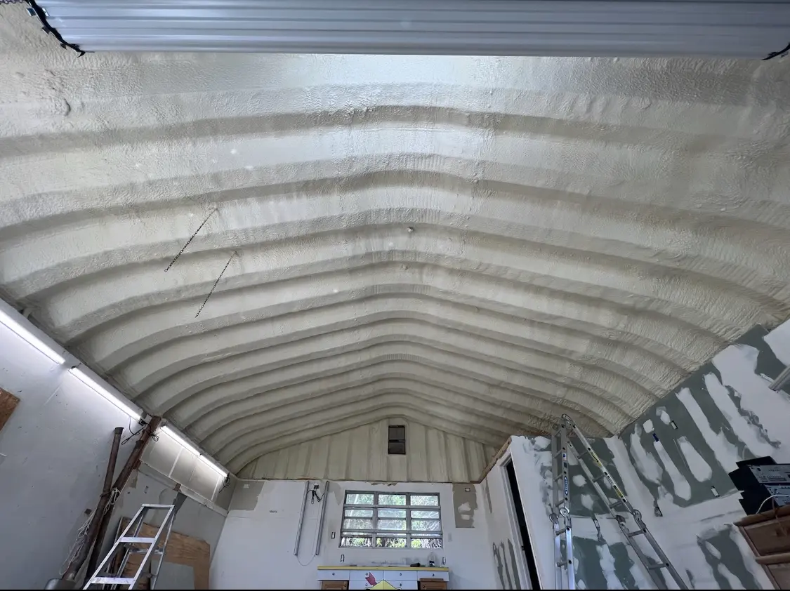 Spray polyurethane foam applied to the underside of a metal roof deck in Howard